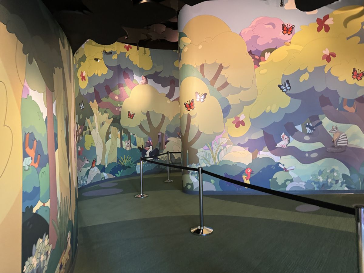 The painted forest mural inside the Blueys Backyard Bash queue