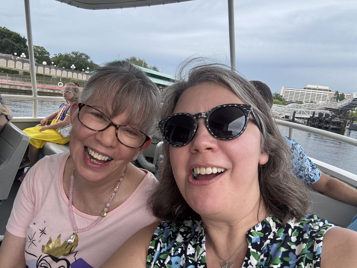 Vanessa and her mom laughing on the boat to Wilderness Lodge