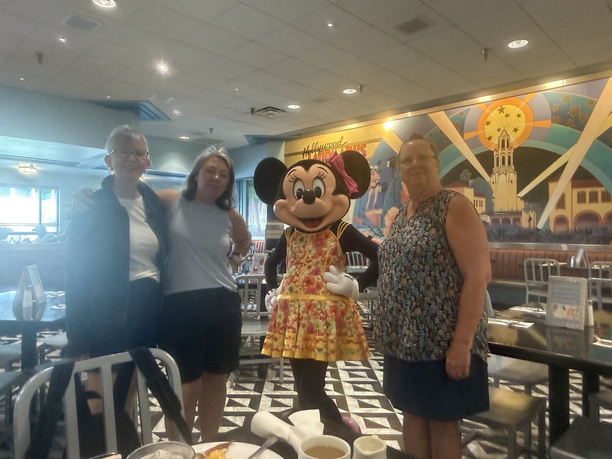 Vanessa, her mom, and a friend posing with Minnie Mouse at Hollywood and Vine