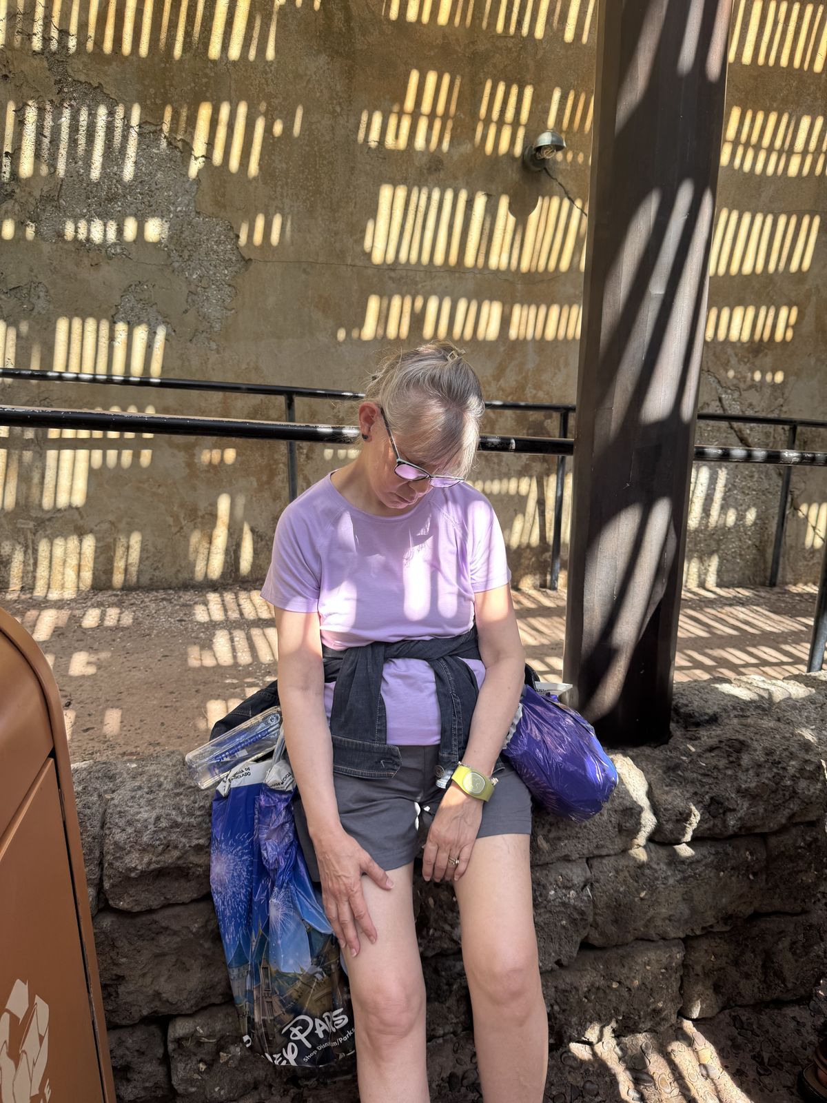Vanessas mom asleep again, this time waiting in line for Festival of the Lion King