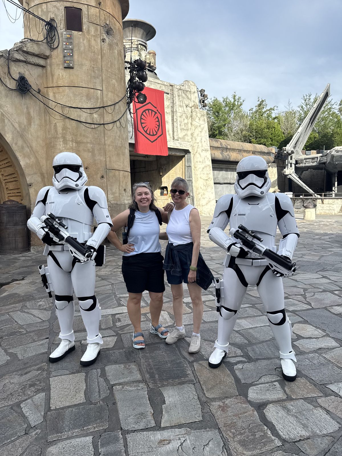 Vanessa and her mom posing with two stormtroopers